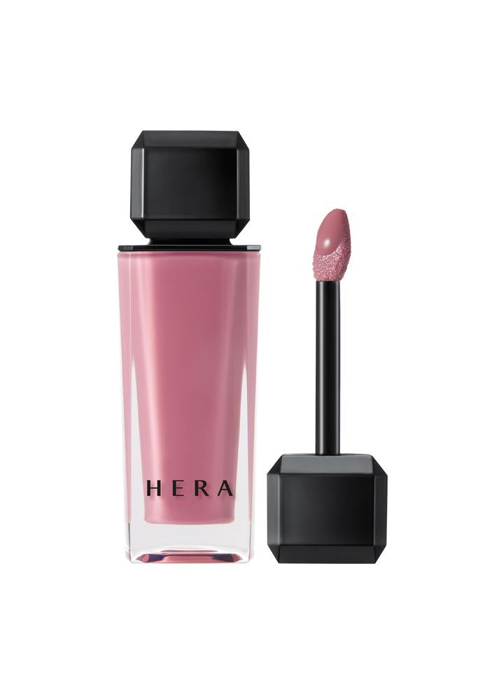 Hera Sensual Nude Gloss 5g — clear wand applicator showing glossy formula on neutral backdrop